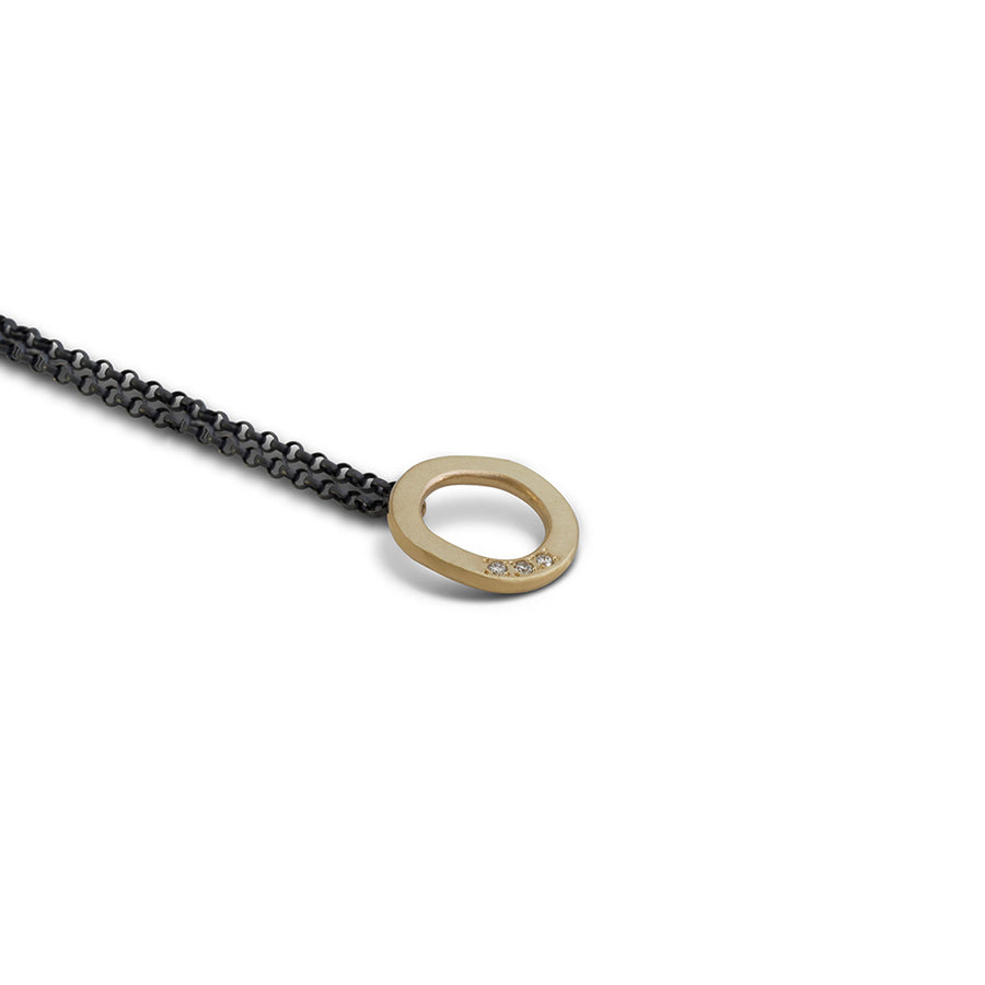 Gold studded halo pendant on oxidised silver chain