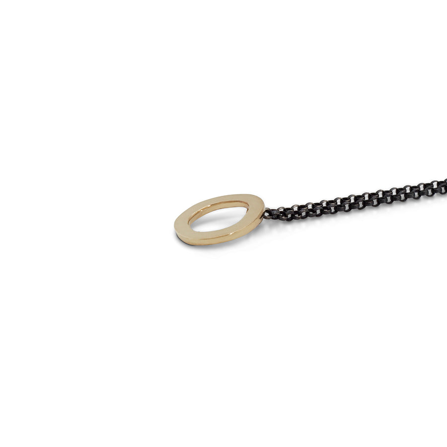 Gold halo pendant on oxidised silver chain