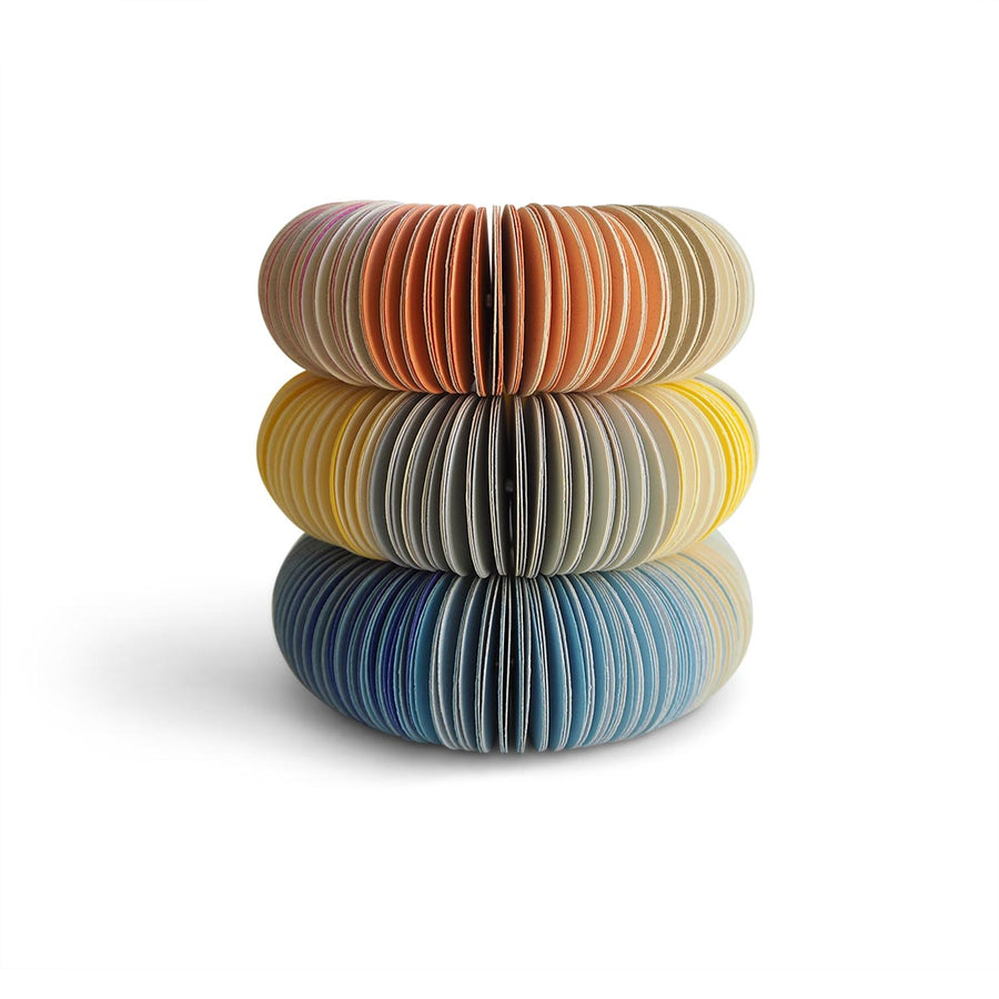 paper bangle stack. Peach, grey, blue