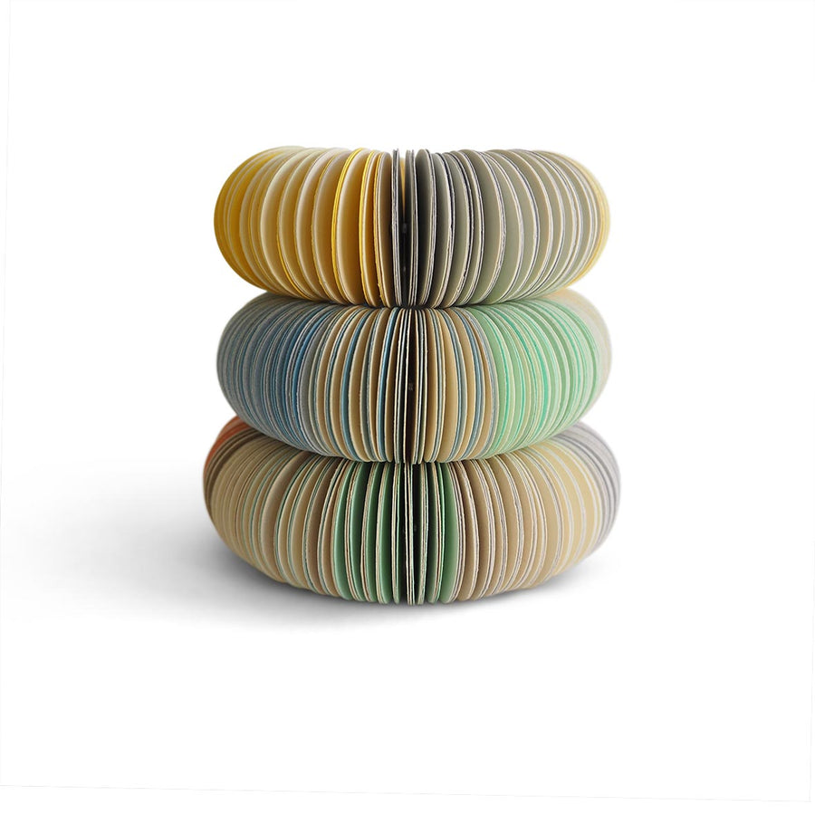 paper bangle stack. Yellow, mint, peach